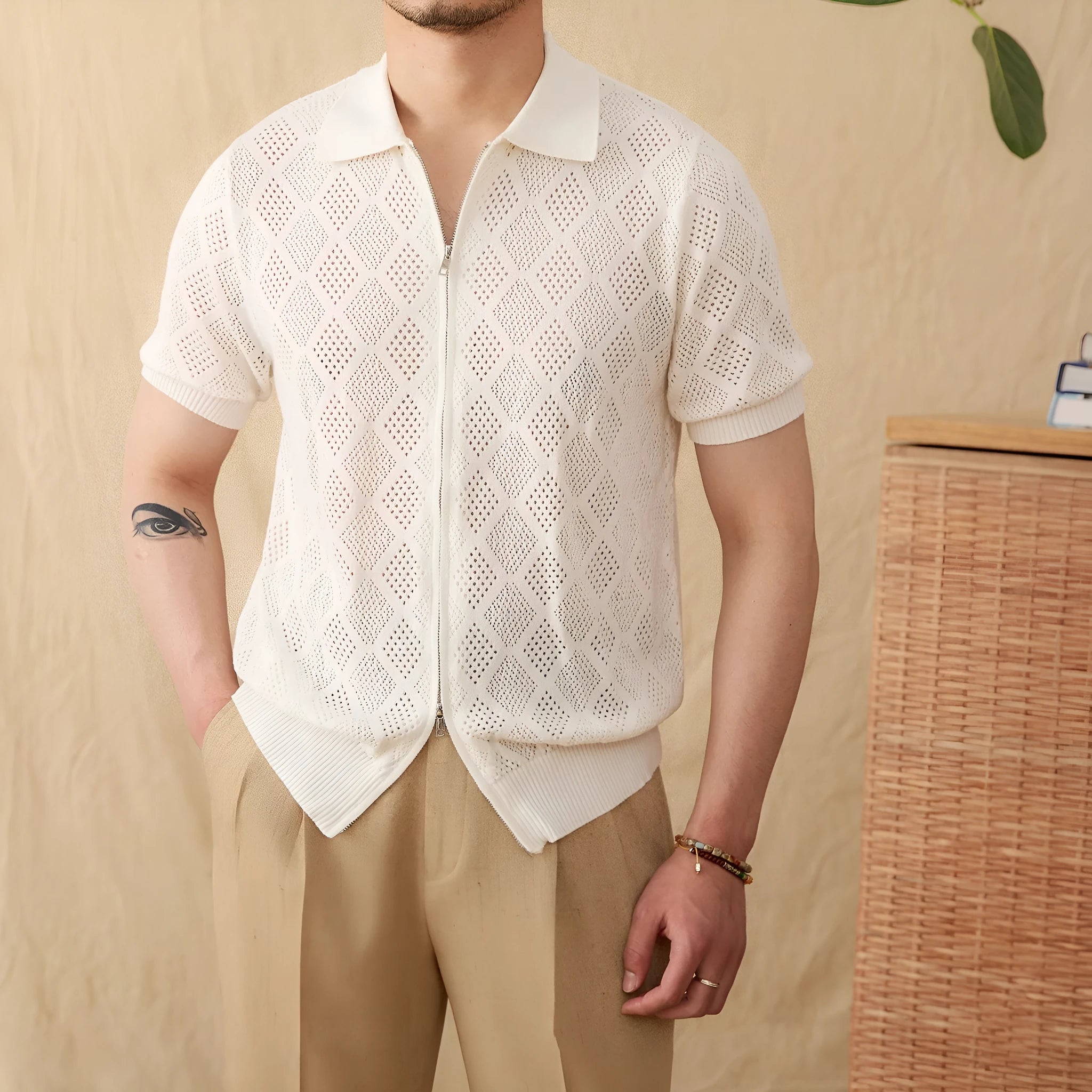 Light brown cotton short sleeve cardigan with lapel collar and front zipper closure on hanger