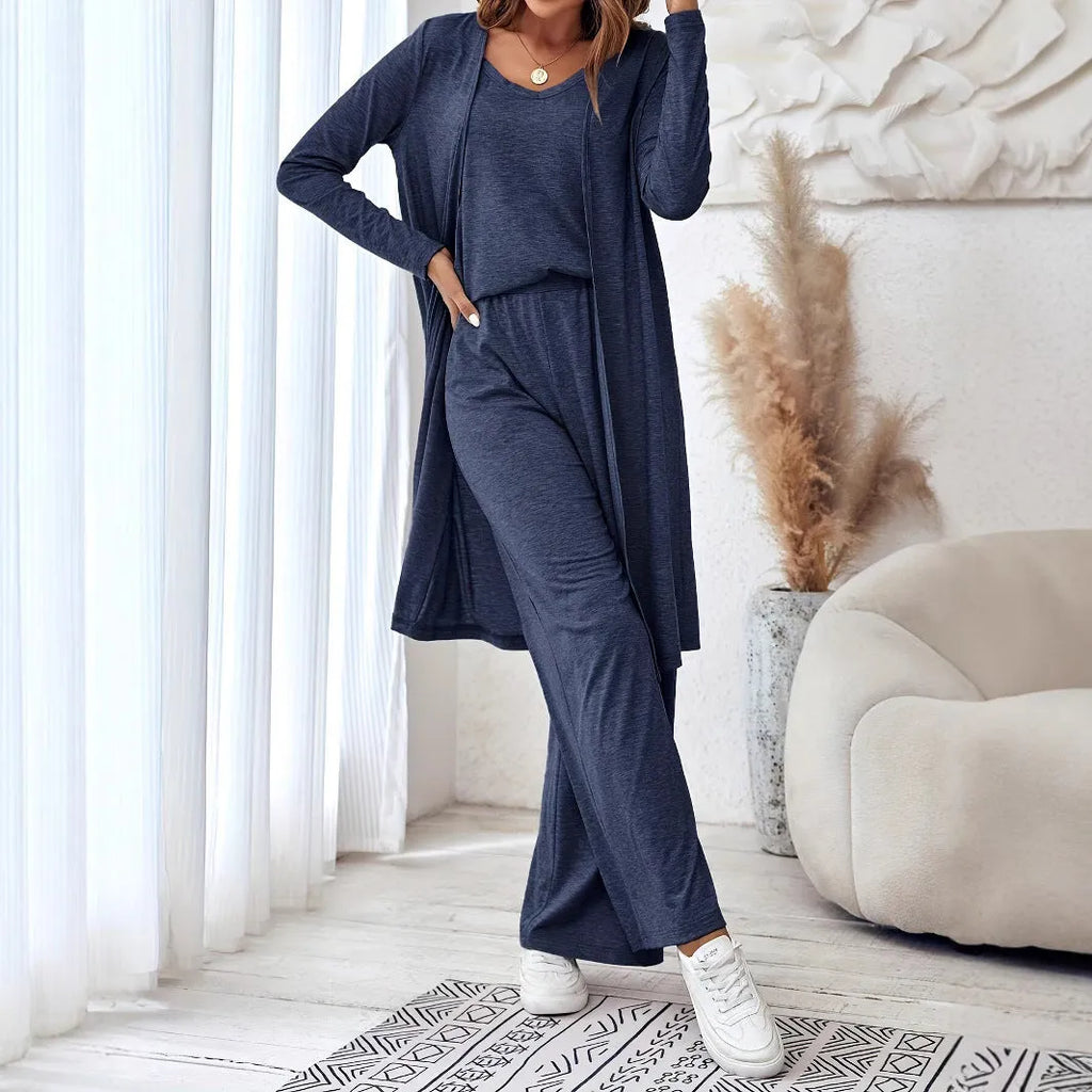 Blue women's polyester suit set with sling top, long cardigan, and trousers on a hanger.