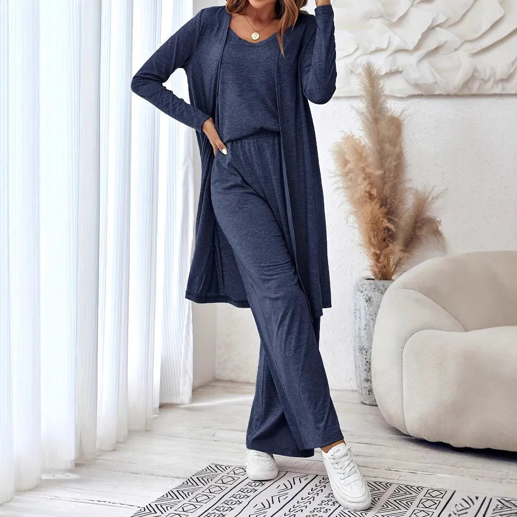 Blue women's polyester suit set with sling top, long cardigan, and trousers on a hanger.