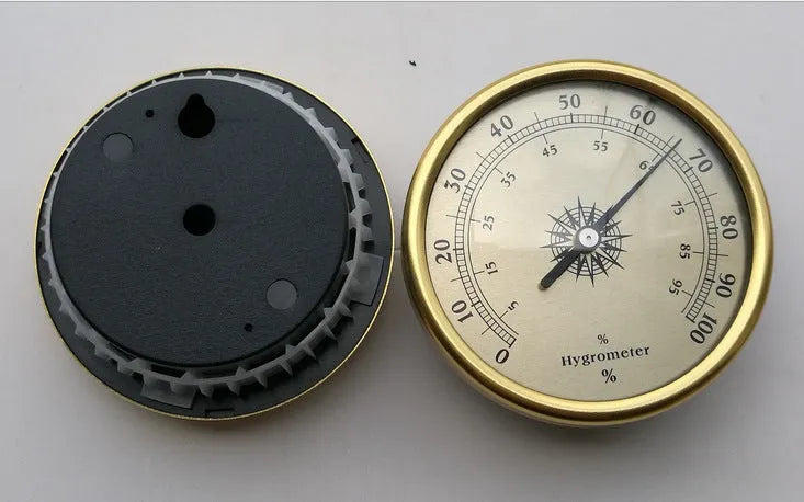 Analog thermometer and hygrometer with aluminium ring and dial showing temperature and humidity scales.