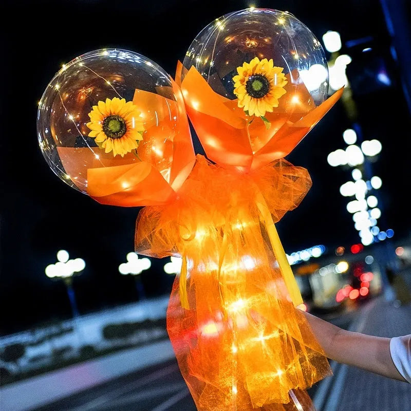 Transparent LED luminous balloon with artificial rose and built-in light, shown as a DIY bouquet kit.
