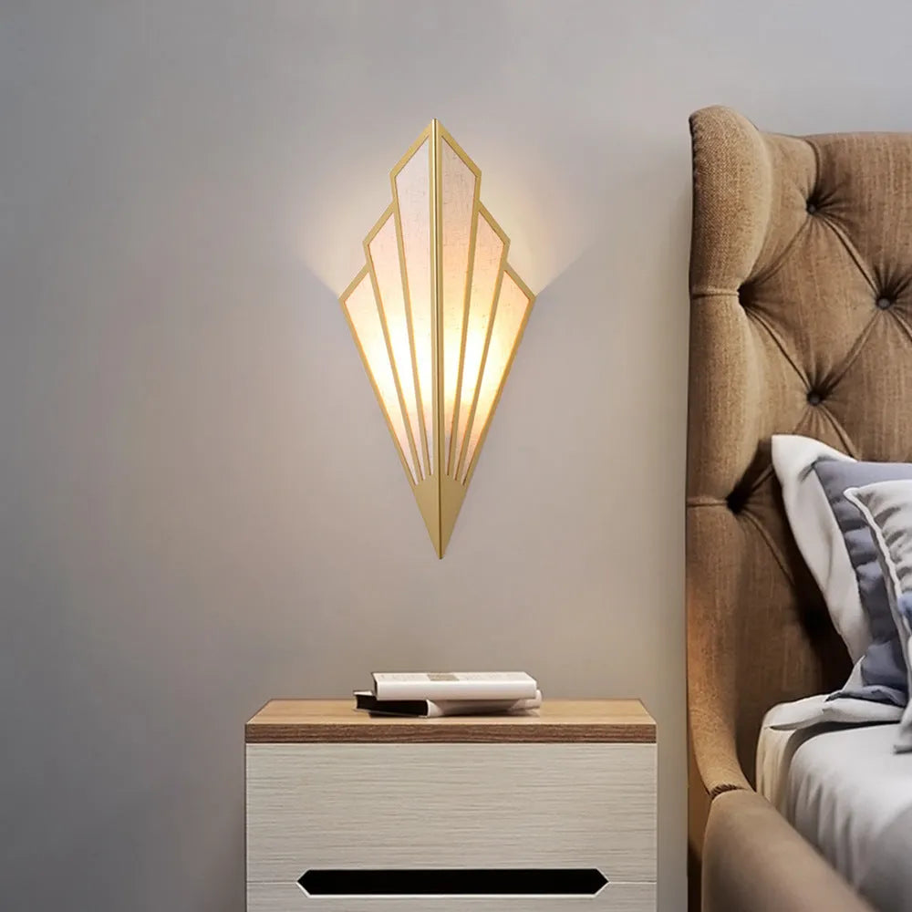 Black wrought iron and linen wall lamp with round shade, mounted on a corridor wall, 18cm diameter