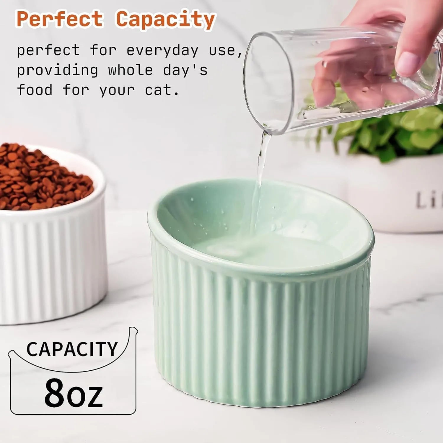 A dark green ceramic elevated cat bowl with a tilted, round shape.