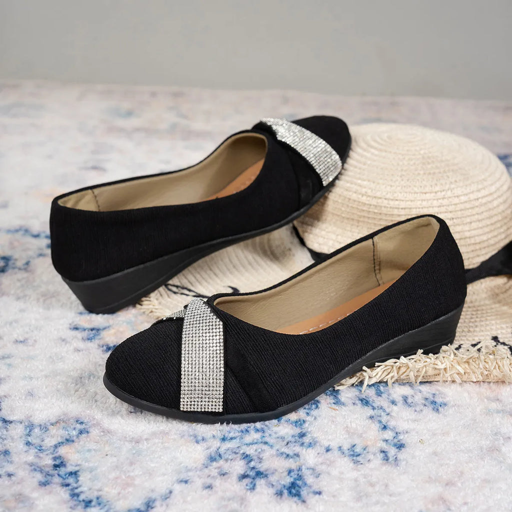 Black women's low-cut slip-on casual shoes with rhinestone decoration and a chunky short heel.