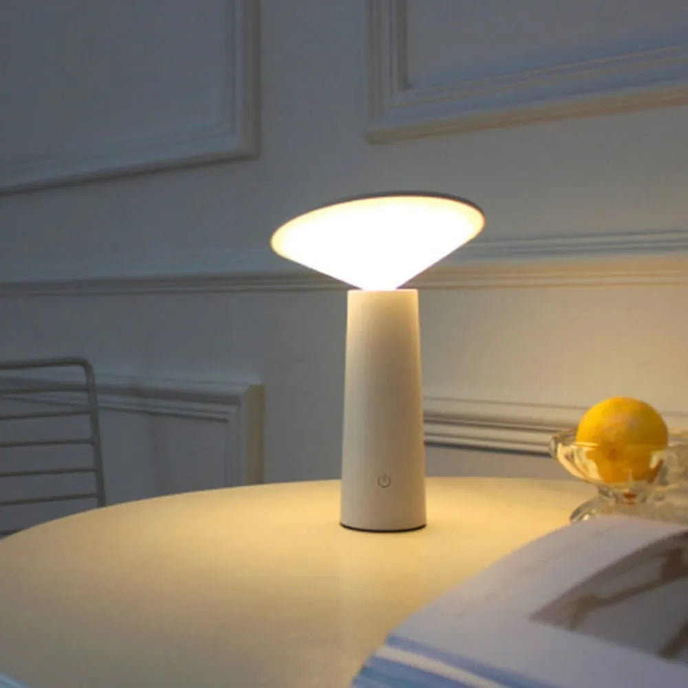 Black USB touch sensor reading lamp with tilted head on a wooden desk