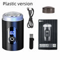 Black mini rechargeable shaver with USB cable and cleaning brush on a table