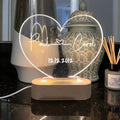Custom engraved acrylic LED night light showing illuminated personal names and dates