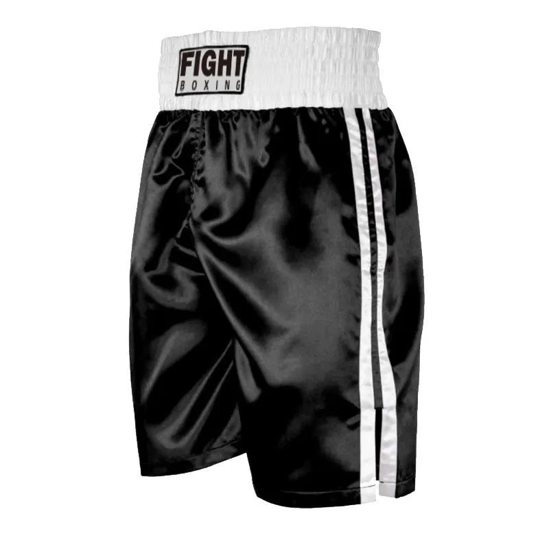 Man wearing black and white boxing shorts with side stripes during a training session