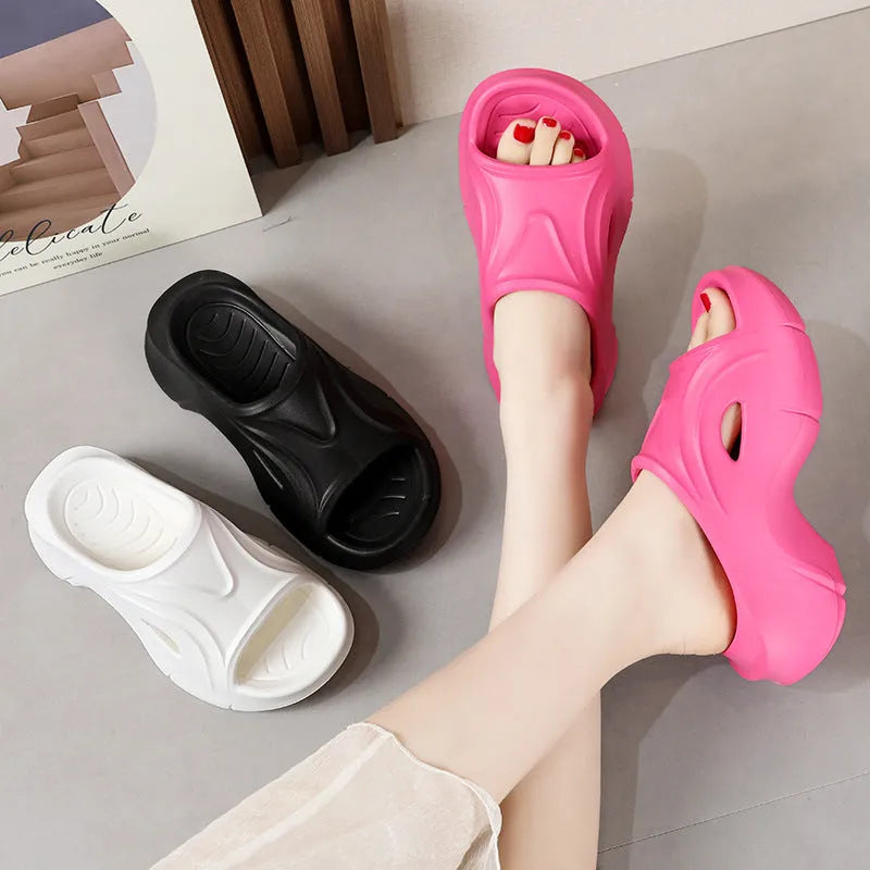 Women's white EVA slippers with thick sole and round toe on a beach background