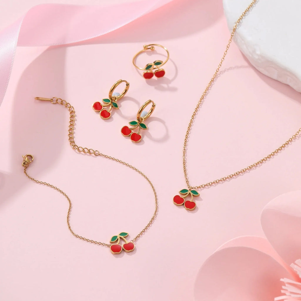 Cherry shaped jewellery set with necklace, bracelet, earrings, and ring in gold-plated stainless steel