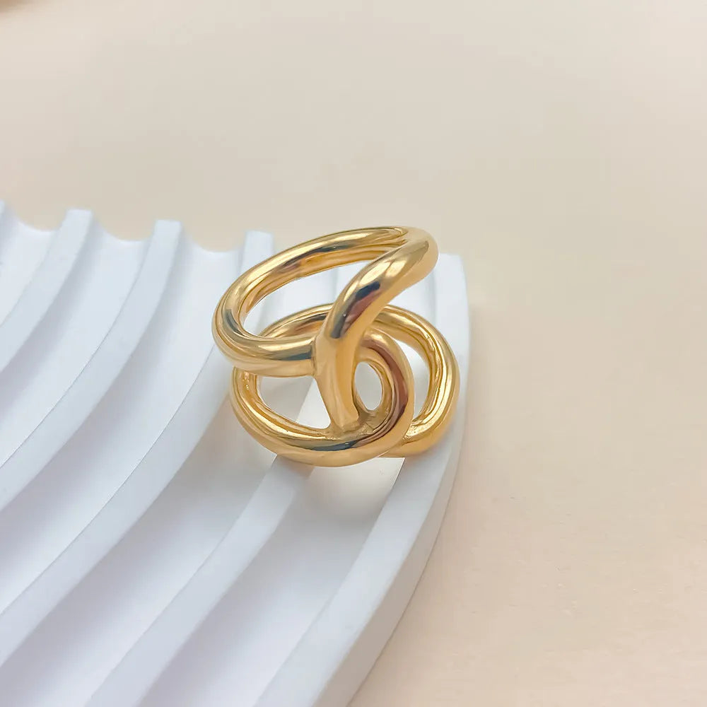 Adjustable stainless steel ring for women with a knotted geometric U-shape design in gold or silver tone.