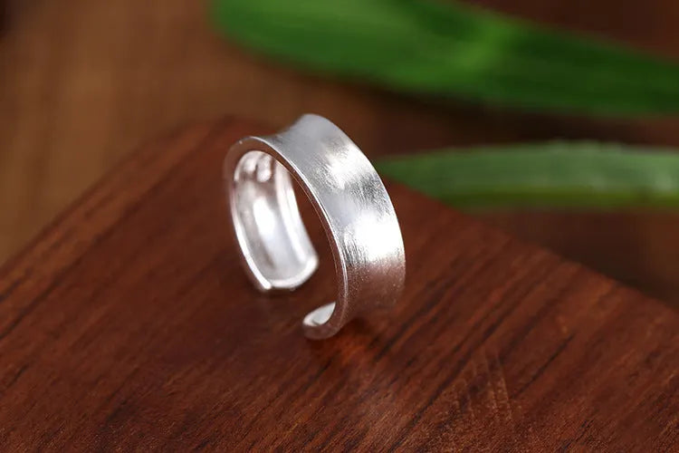 Korean frosted sterling silver geometric open ring with adjustable size on display