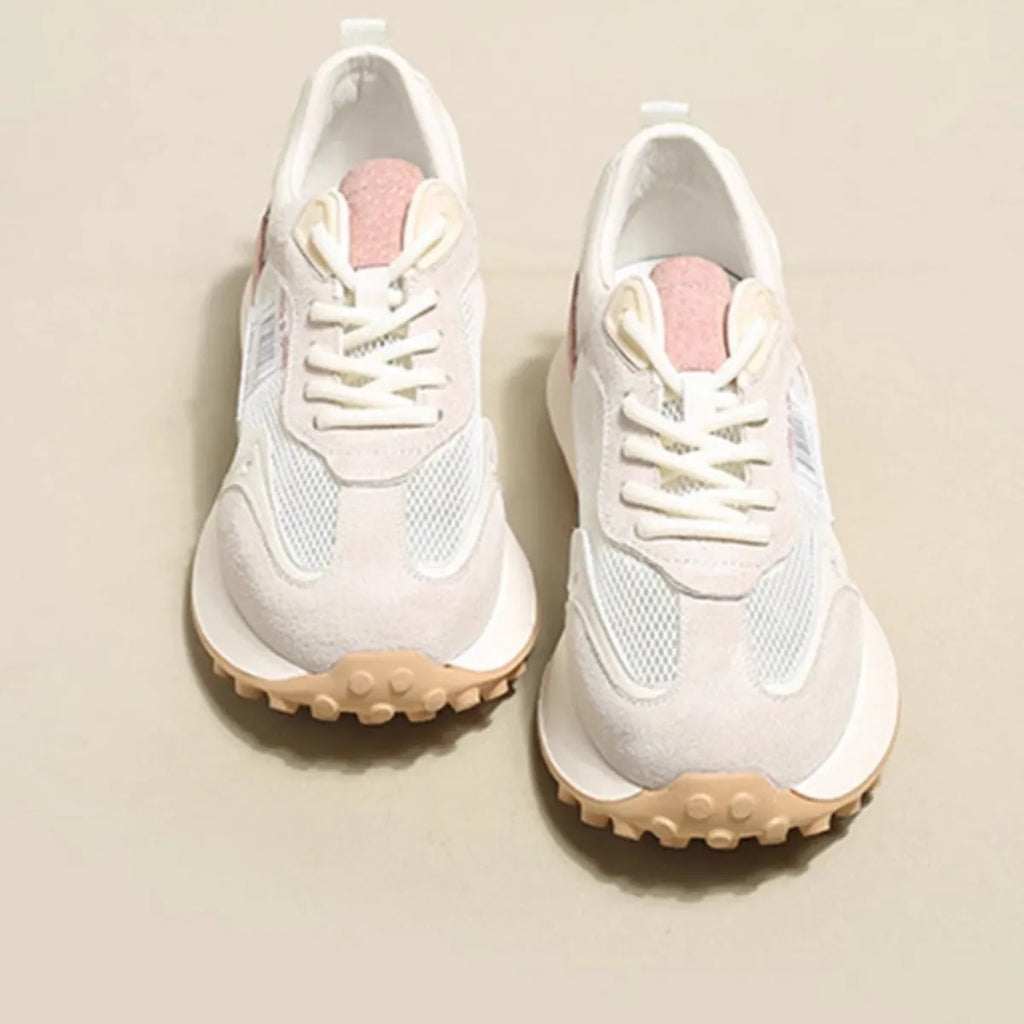 Grey and pink women's low-top retro sneakers with round toe and shallow mouth on a rubber sole.