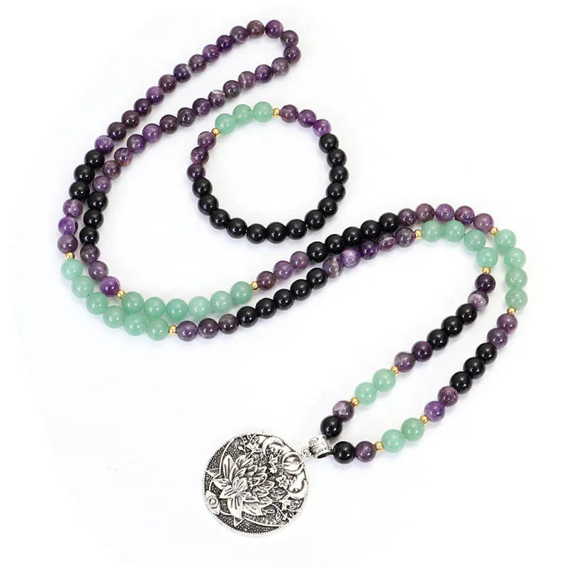 Lotus pendant necklace with stone beads on adjustable ball bead chain alongside matching bracelet