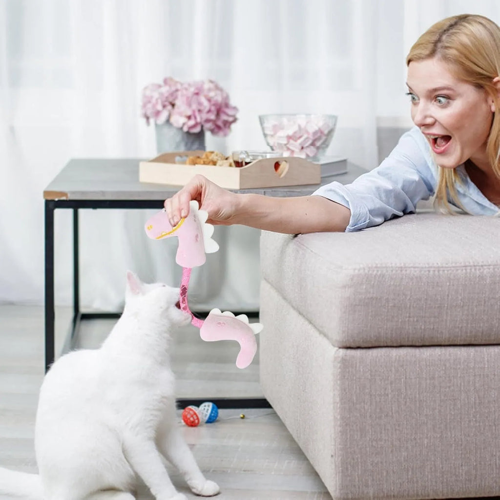 Four cat toys including rope, springs, and plush kicker toys in assorted colours