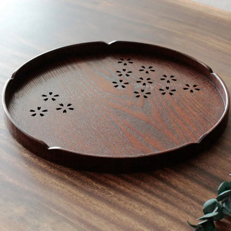 Wooden shallow plate with etched cherry blossom design, approximately 30 cm in diameter.