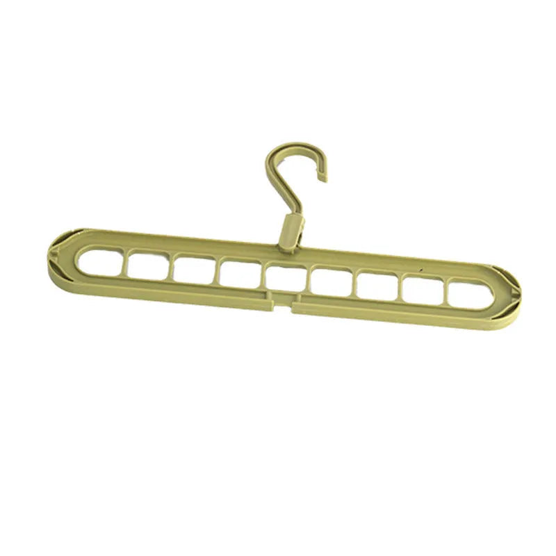 Green plastic nine-hole folding pant hanger for trousers and skirts.