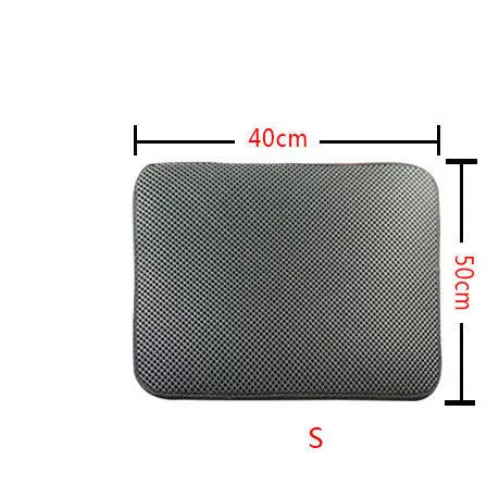 Double layer EVA cat litter mat in black with textured surface, placed under a litter box to trap debris