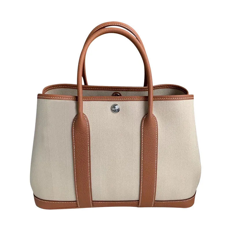 Women's canvas crossbody shoulder tote bag with leather detailing and bucket shape