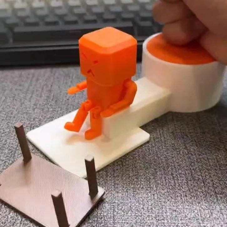 Orange plastic vent decompression fidget toy on a table, showing its 16cm length and turning mechanism.