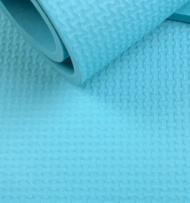 EVA fitness yoga mat in red showing textured anti-skid surface with storage bag