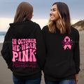 Women's pink breast cancer awareness pullover hoodie with retro graphic design and side seam pockets.