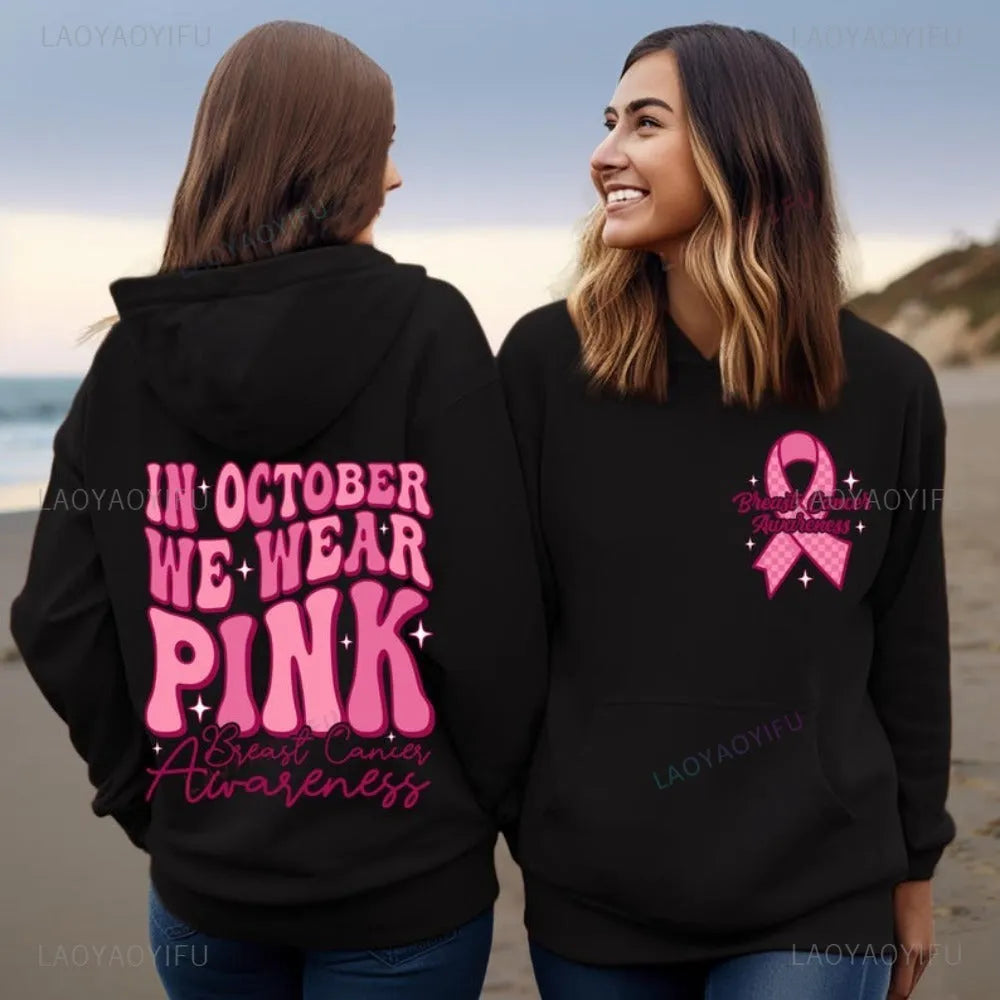 Women's pink breast cancer awareness pullover hoodie with retro graphic design and side seam pockets.