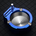 Large blue metal cigarette ashtray with a built-in permanent match lighter and three cigarette slots.