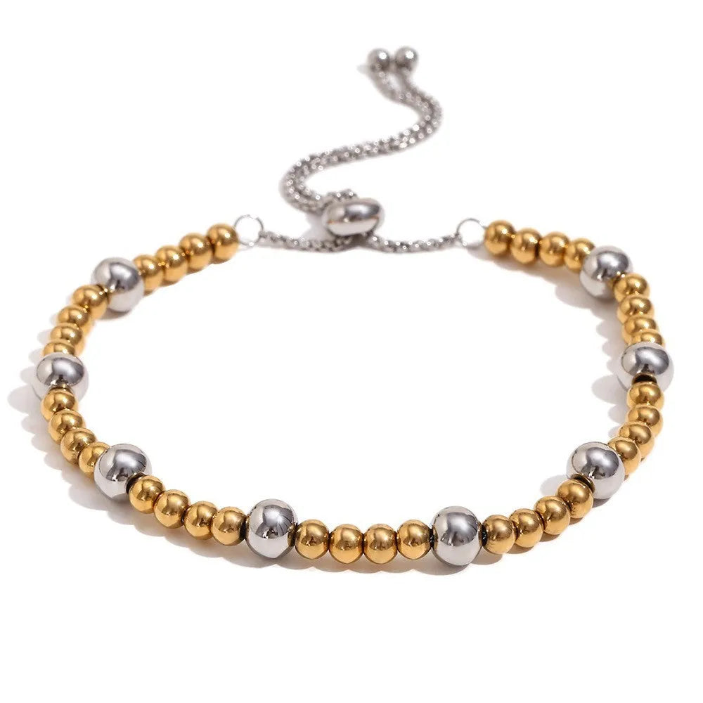 Women's geometric gold stainless steel jewellery set showing earrings, bracelet and necklace