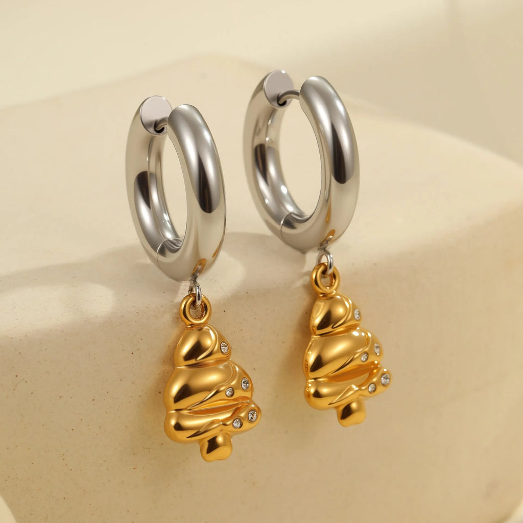 A pair of stainless steel earrings with an 18K gold colour finish, shown in a Christmas tree shape and a heart shape.