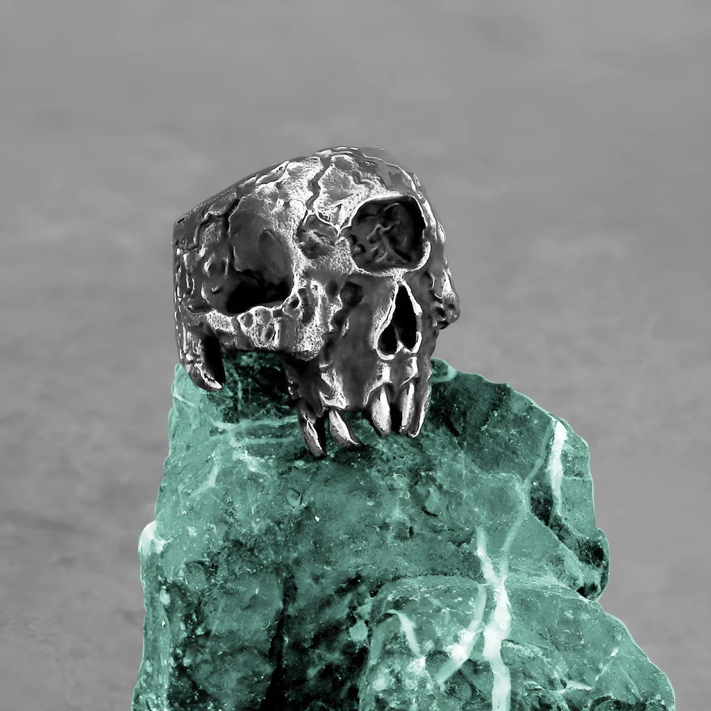 Alloy skull ring with one-eyed design in electroplated finish shown on finger