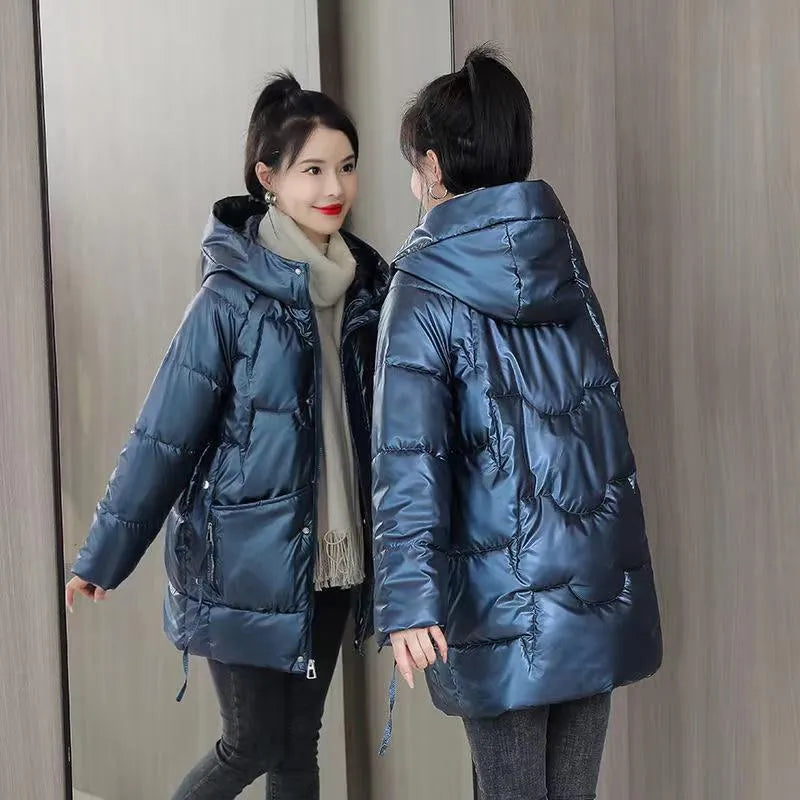 Women's loose fit hooded winter jacket in green colour showing long sleeves and thick insulation
