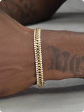 Gold tennis bracelet with stone detailing on titanium steel band