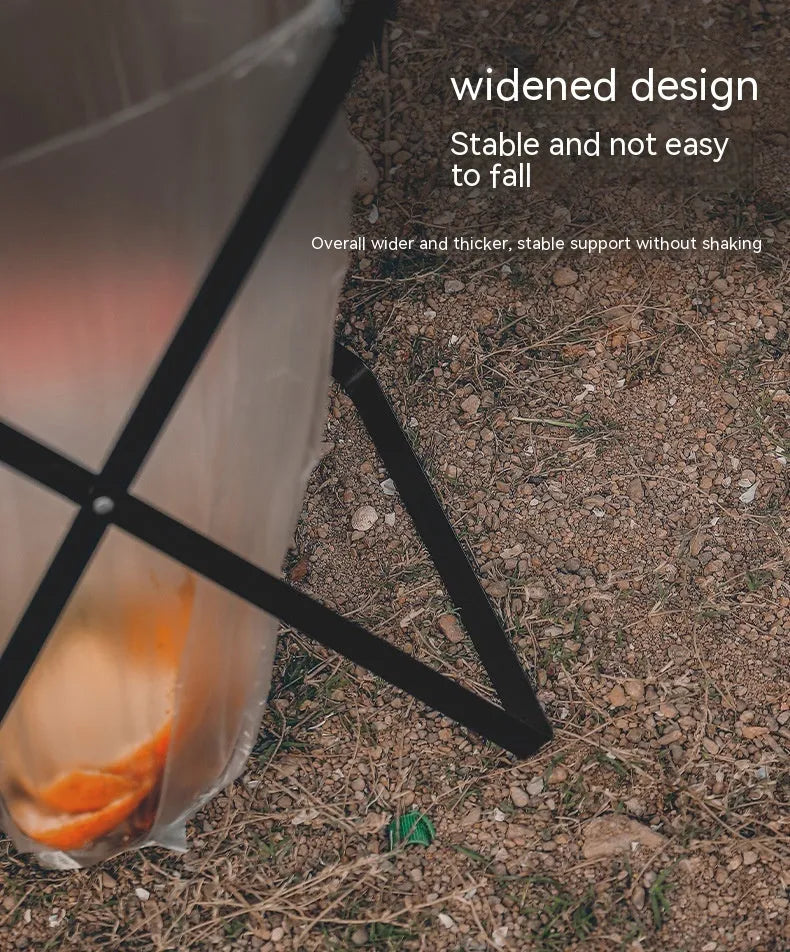 Black folding outdoor trash rack with a wooden handle, holding a rubbish sack.