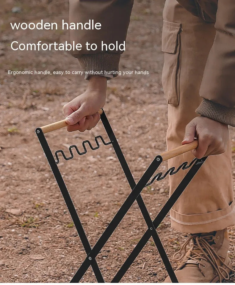 Black folding outdoor trash rack with a wooden handle, holding a rubbish sack.