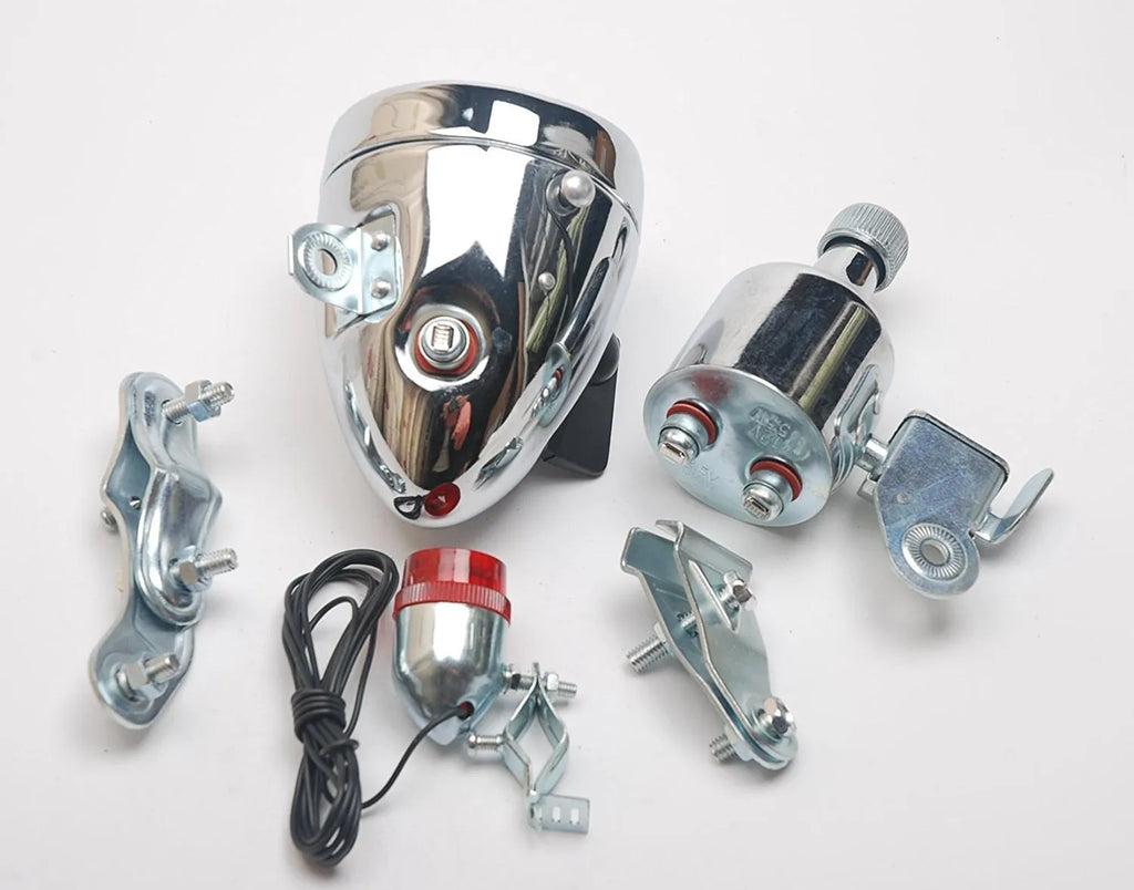 Silver aluminium bicycle dynamo light kit with generator, headlight, and tail light for friction-powered illumination.