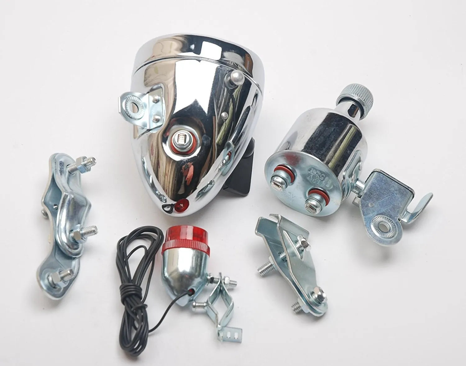 Silver aluminium bicycle dynamo light kit with generator, headlight, and tail light for friction-powered illumination.