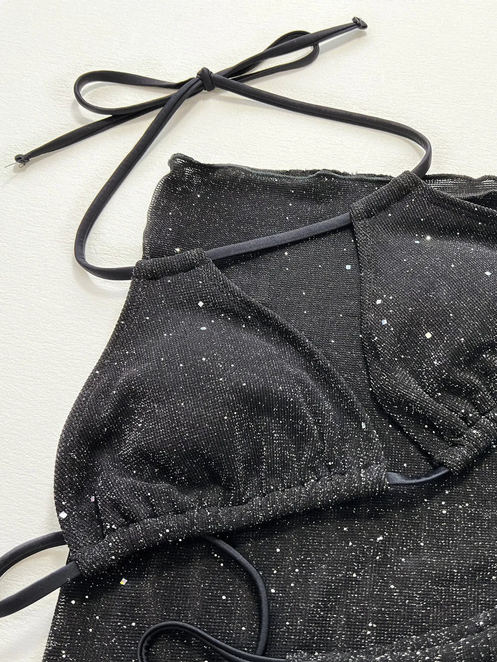 Black three-piece bikini swimsuit set with polyester construction showing front view
