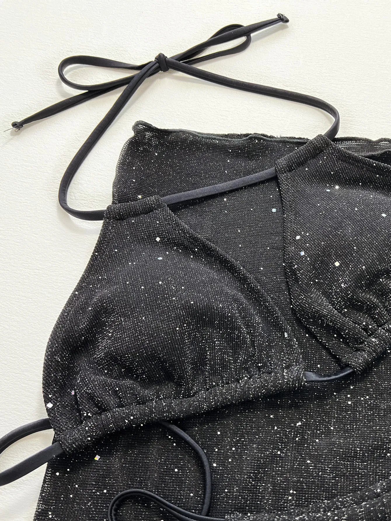 Black three-piece bikini swimsuit set with polyester construction showing front view