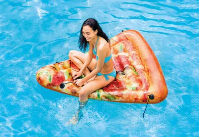 Large green and red pizza slice inflatable surfboard floating on water