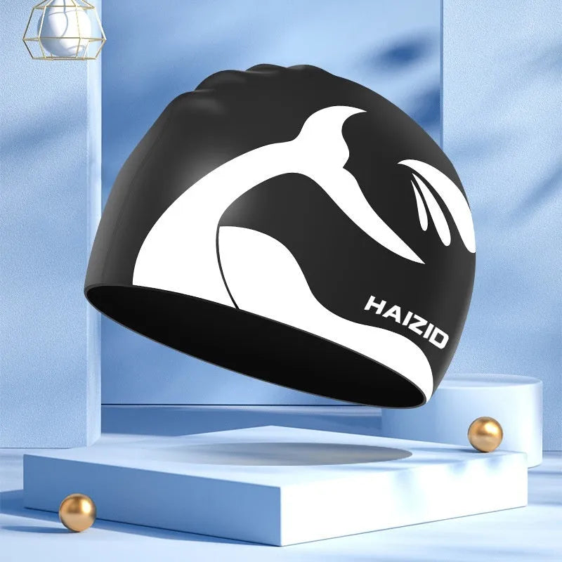 Silicone swim cap with waterproof ear protectors featuring whale tail design in multiple colours