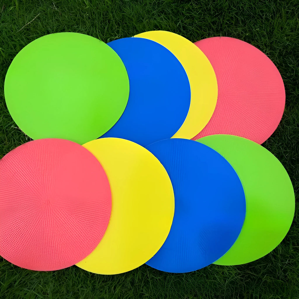 Yellow TPE football training target disc on grass, 23cm diameter flat landmark pad