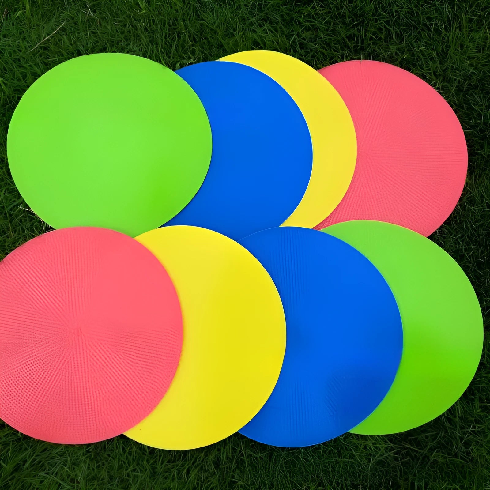 Yellow TPE football training target disc on grass, 23cm diameter flat landmark pad