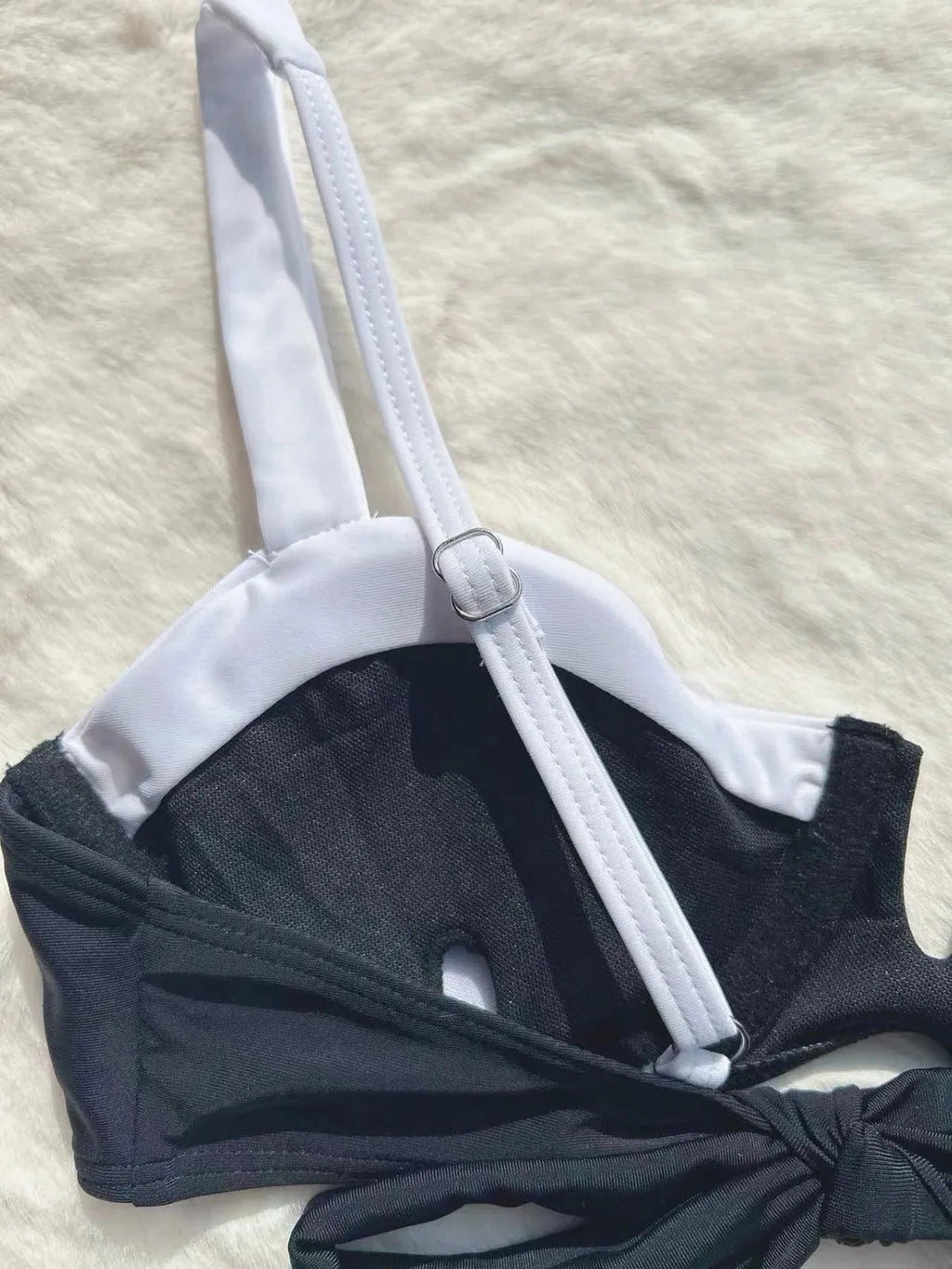 Black women's low-waist bikini swimsuit with brief bottoms and side stitching.