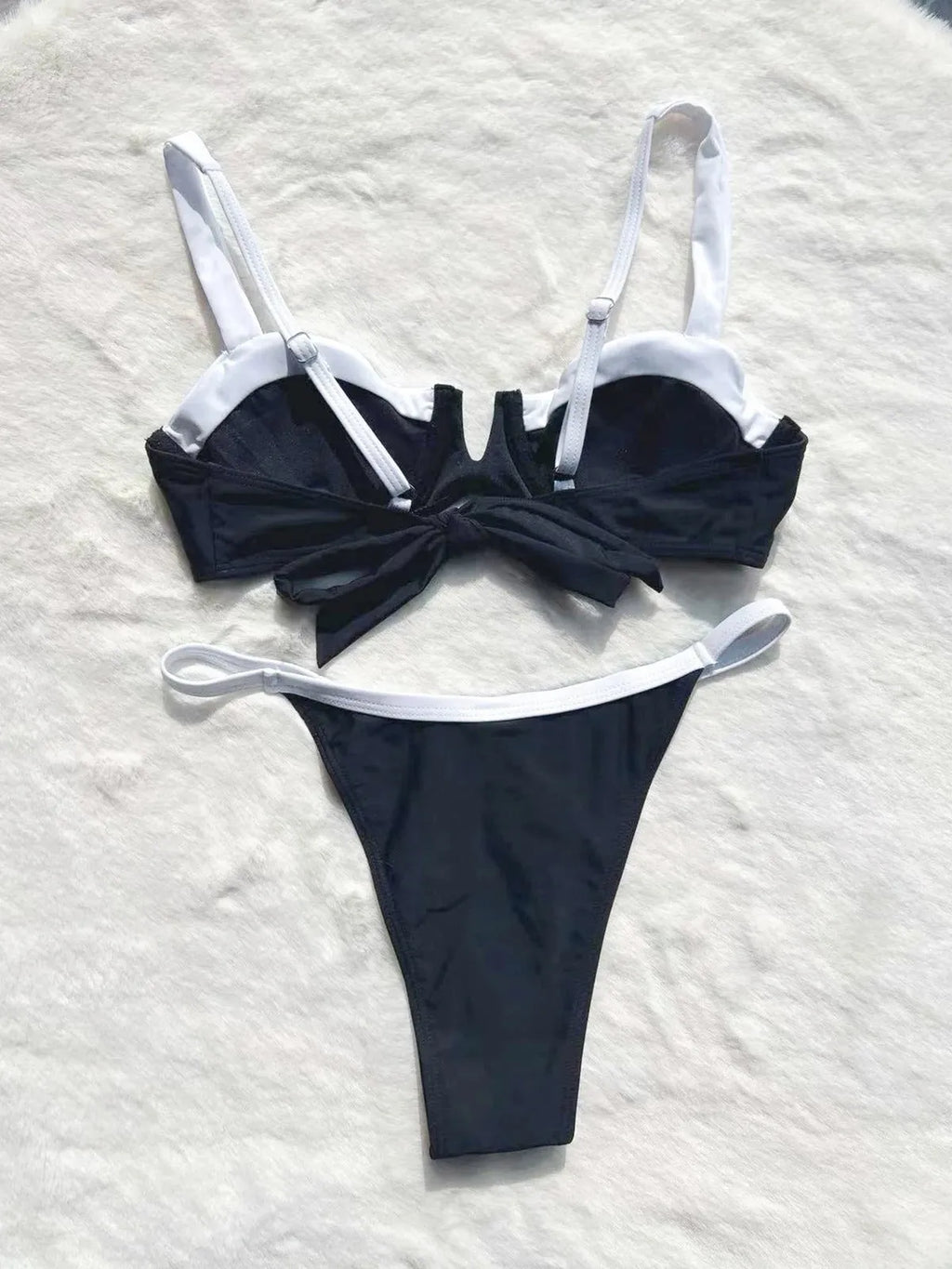 Black women's low-waist bikini swimsuit with brief bottoms and side stitching.