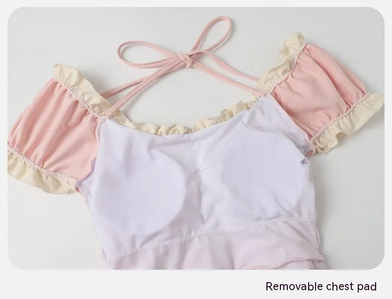 Pink conservative one-piece swimsuit with Siamese-themed detailing for women in nylon fabric