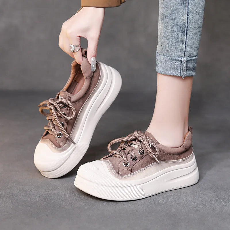 Women's yellow lace-up casual leather shoes with round toe and rubber sole on a neutral background.