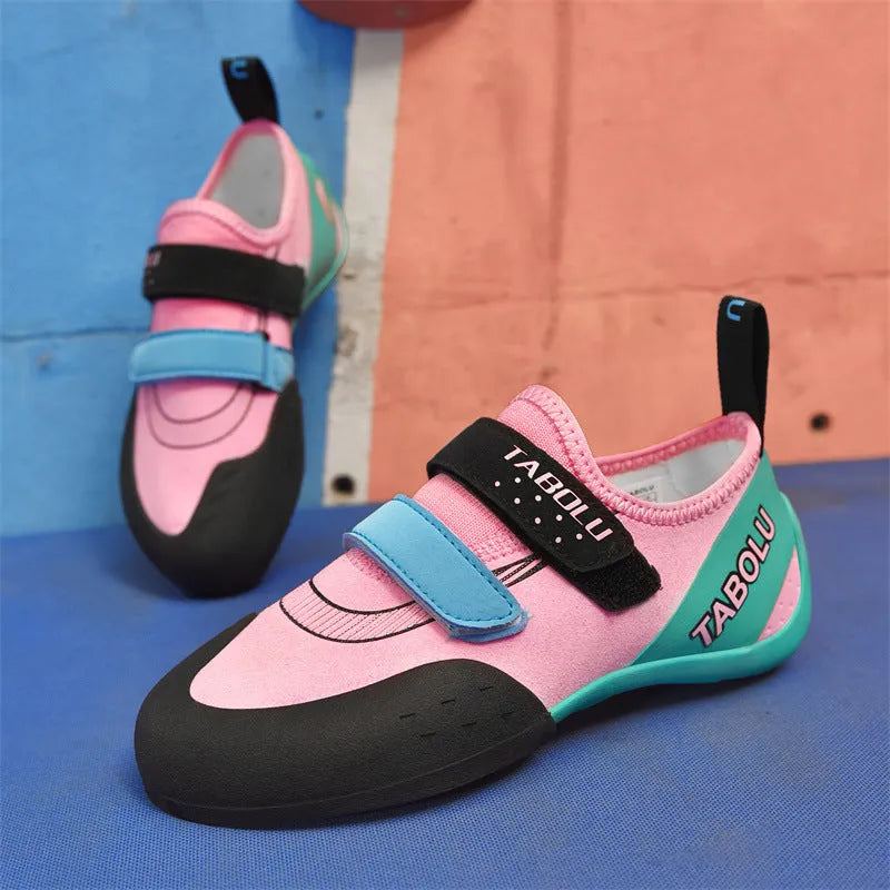 Beginner rock climbing shoes with Velcro strap in black and red colour.