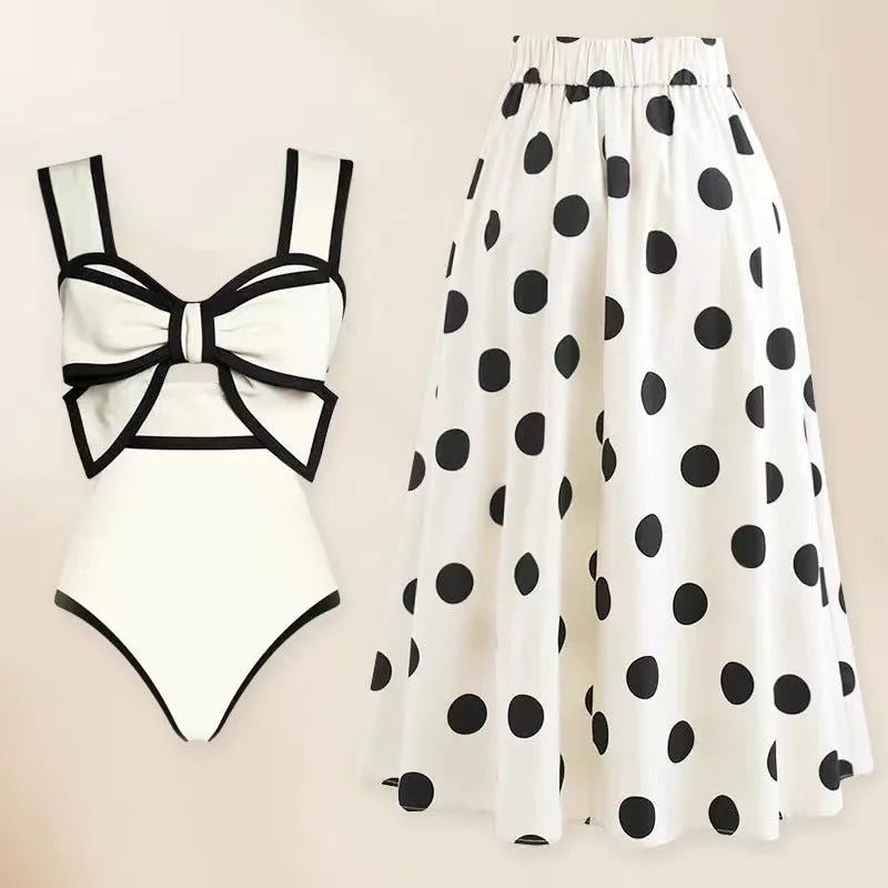 Women's black one-piece swimsuit with white round skirt and bow detail for beach and swimming