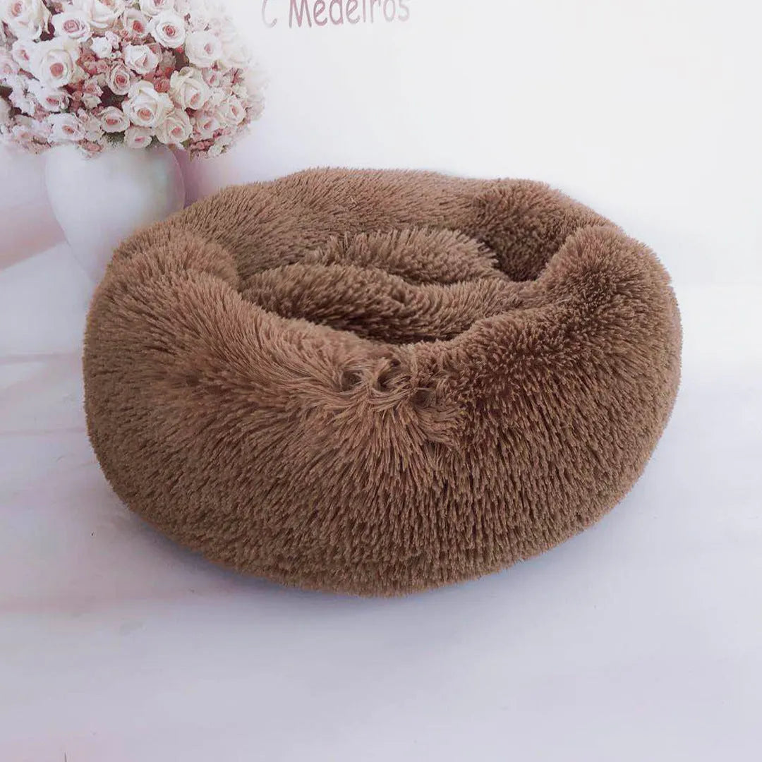 Plush pet nest in apricot colour on floor, soft cloth circular dog bed 40cm diameter indoor use